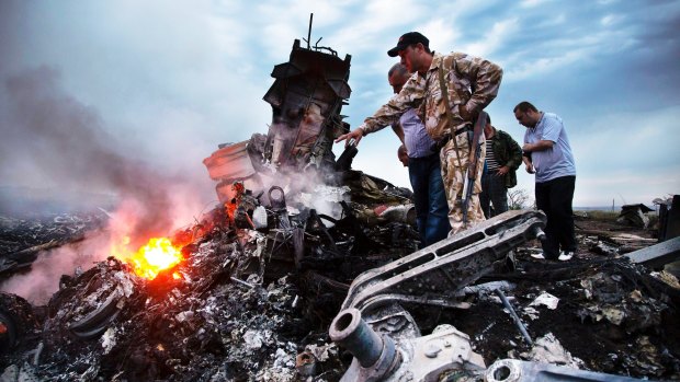 Inspectors search the MH17 crash site in Ukraine, in July, 2014. 