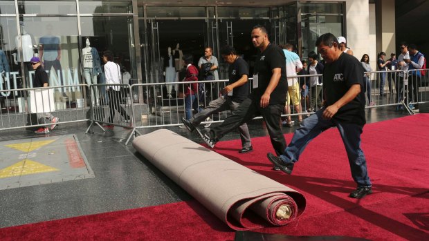 Workers roll the red carpet outside the Dolby Theatre at last year's awards.