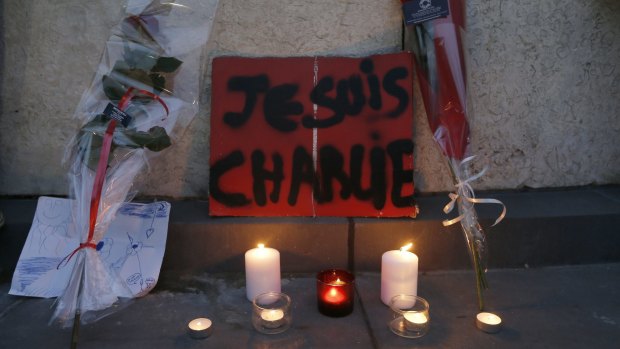 Flowers, candles and a placard which reads "I am Charlie" at a gathering at the Place de la Republique in Paris.