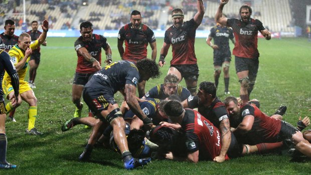 Deluge: Crusaders players celebrate a try in Christchurch.