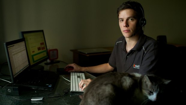 Dylan Nelson works from his South Windsor home taking customer calls for
an internet service provider.