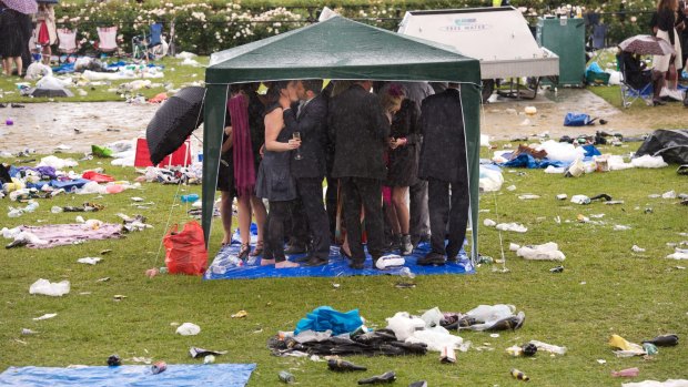 Racegoers take shelter at the Melbourne Cup in 2010. 
