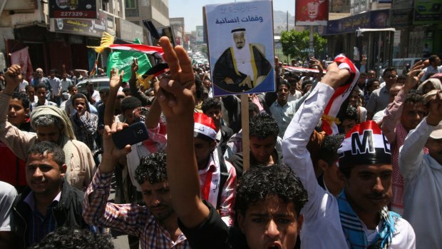 Yemenis in the southern city of Taiz hold a poster of King Salman of Saudi Arabia at a rally to show support for Saudi-led air strikes.