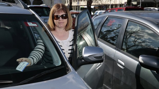 Joanne Palisi of Hughes pays for parking on Saturday afternoon at the carpark of the Canberra Museum and Art Gallery. 
