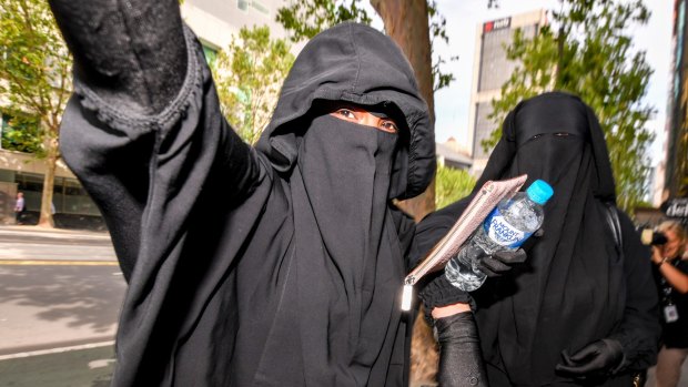 Two women believed to be friends or family of the accused terrorists leave Melbourne Magistrates Court. 