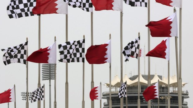 Bahraini and chequered racing flags fly in front of the tower at the Bahrain International Circuit, venue of this weekend's Formula 1 Grand Prix.