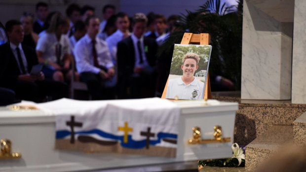 A portrait of 18-year-old one-punch victim Cole Miller is placed near the coffin.
