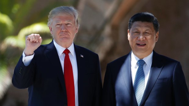 Donald Trump and Xi Jinping pose for photographs at Mar-a-Lago.  