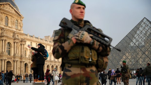 A soldier stands guard outside the Louvre museum, in Paris.