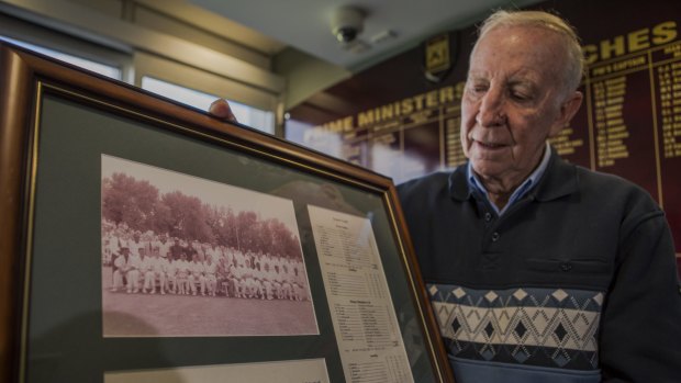 Canberra's John Cope, with the team photo of the 1961 Prime Minister's XI team and Richie Benaud.