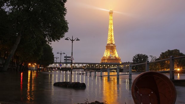 Water rises by night near the Eiffel Tower as the Seine river's embankments overflow after four days of heavy rain.