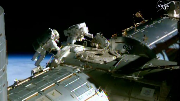 NASA astronauts Barry Wilmore (left) and Terry Virts during a spacewalk to lay cable on the International Space Station. 