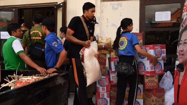 Taskforce members load supplies for evacuees