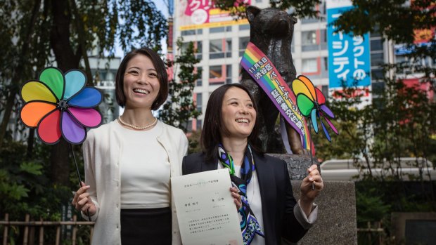 Japanese couple Koyuki Higashi, left, and Hiroko Masuhara hold up their certificate in Tokyo's Shibuya ward on Thursday, November 5.