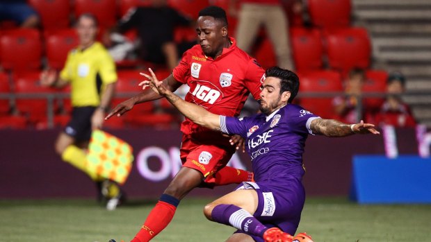 Rhys Williams, in Glory colours, tackles Adelaide Utd's Mark Ochieng during the A-League season.