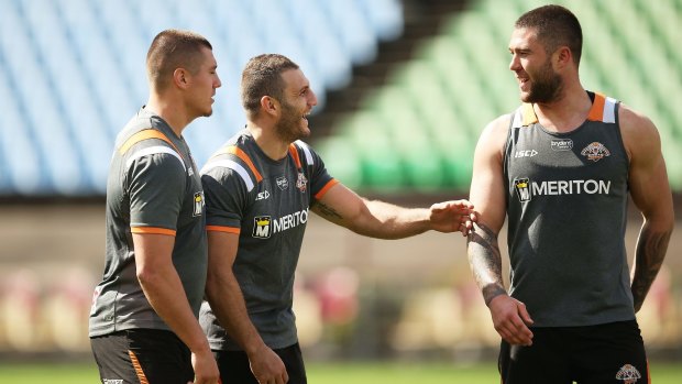 Still able to laugh: Robbie Farah shares a joke with teammates at Wests Tigers training.