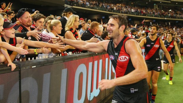 Big night: Jobe Watson of the Bombers celebrates the win with fans at the MCG on Saturday night.