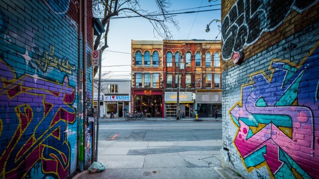 Street art in Graffiti Alley and buildings on Queen Street West, in the Fashion District of Toronto. 