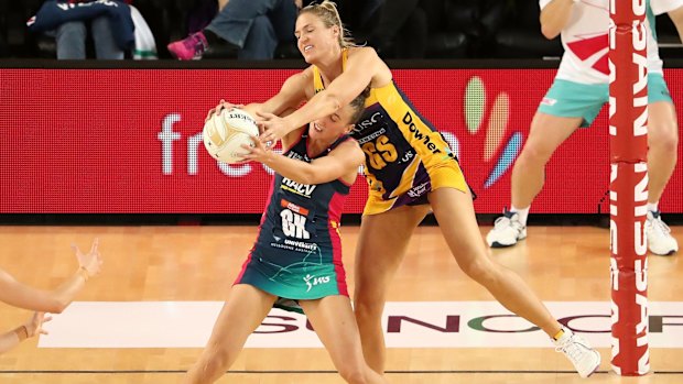 MVP Caitlin Bassett of the Lightning wrestles with Melbourne Vixens' Emily Mannix.