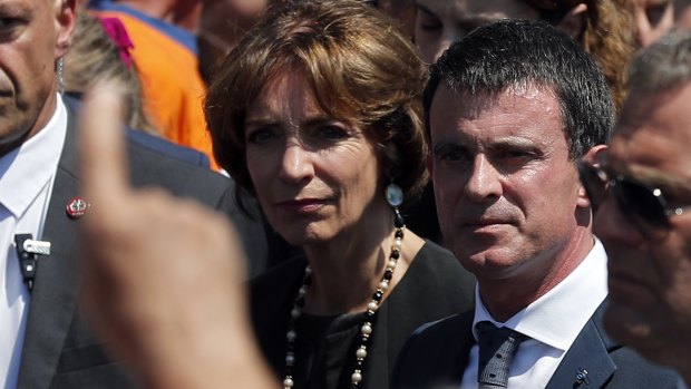People boo French prime minister Manuel Valls, center, and Health Minister Marisol Touraine, after a minute of silence in NIce.