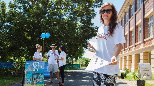 A volunteer from GetUp hands out how-to-vote cards during the Queensland election in 2015.