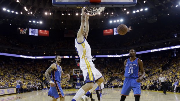 Throwing the hammer down: Golden State centre Andrew Bogut dunks past Oklahoma City Thunder's Kevin Durant and Steven Adams.