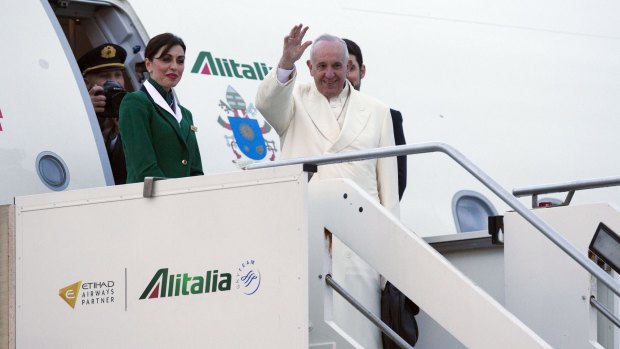 Pope Francis waves as he boards a plane in Rome on his way to Cuba to meet Russian Orthodox Patriarch Kirill.