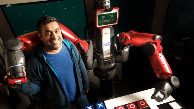 University of Canberra researcher Damith Herath with his robot Baxter, who has been taught to cheat at tic tac toe. 