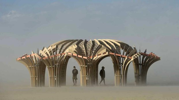 "Burners" inside a sculpture during a dust storm at Burning Man in Nevada