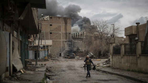 An Iraqi Federal Police officer walked the ruined streets of Mosul on Thursday.