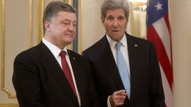 US Secretary of State John Kerry (right) told Ukrainian President Petro Poroshenko Washington "will not close our eyes" to Russian tanks.