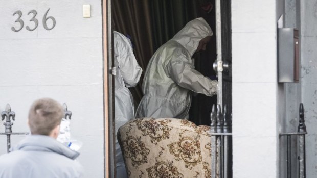 Forensic officers scour a Surry Hills property where a man in his 50s was arrested. 