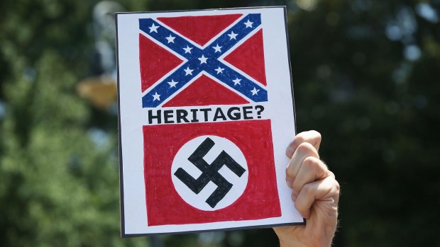 A sign equates the Confederate flag with the Nazi flag as people attend a protest in support of a confederate flags removal from the South Carolina capitol grounds in Columbia.
