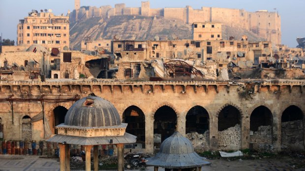 Aleppo citadel, background, and the heavily damaged Grand Umayyad mosque in the old city.