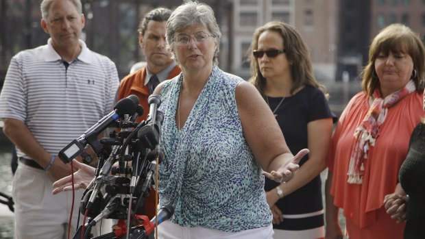 Boston Marathon bombing victim Karen Brassard, surrounded by fellow victims, after the verdict.