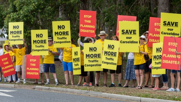 Local residents conduct a protest march against the proposed development at old QUT site in Carseldine on Saturday.