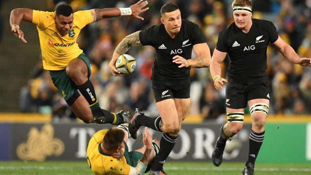 Through the gap: Sonny Bill Williams steps through the tackle of Sean McMahon.