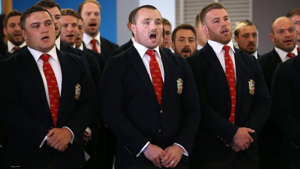 The British & Irish Lions team responds to their welcome with a Welsh song as they arrive at Auckland International Airport.