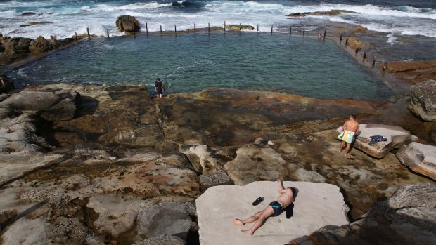 Sunbathers take in the last rays of April and enjoy the sunny weather on offer at Mahon Pool.