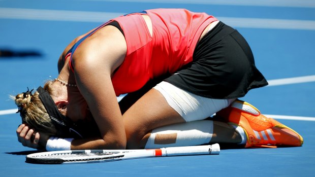 An emotional Mirjana Lucic-Baroni falls to the ground after her win.