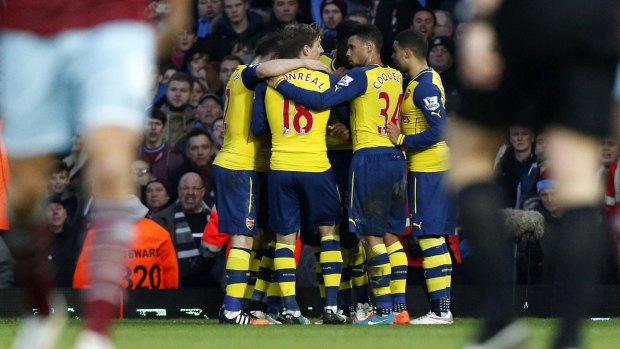 Arsenal players celebrate Santi Cazorla's penalty.