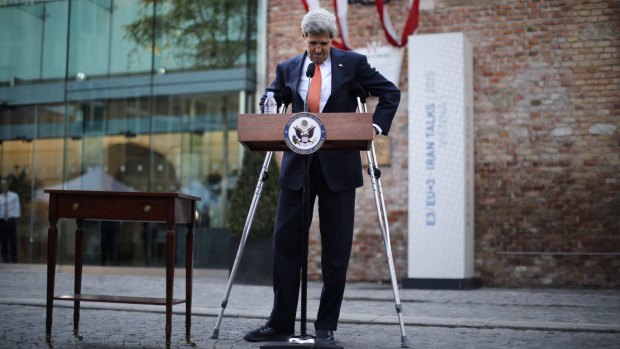 US Secretary of State John Kerry uses crutches  after addressing the media in front of Palais Coburg in Vienna, where  talks with Iran are taking place.