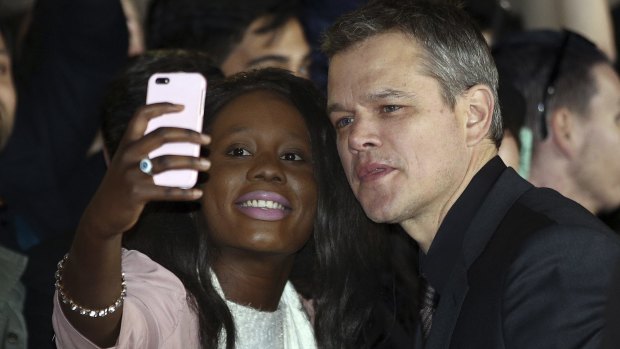 Matt Damon has a selfie taken with a fan at the Australian premiere of <i>Jason Bourne</i> in Sydney last July. 