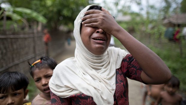 Salema Khatu reacts after seeing a photograph of her son, Habil, who died in an area for Muslim refugees in north of Sittwe, Myanmar. 