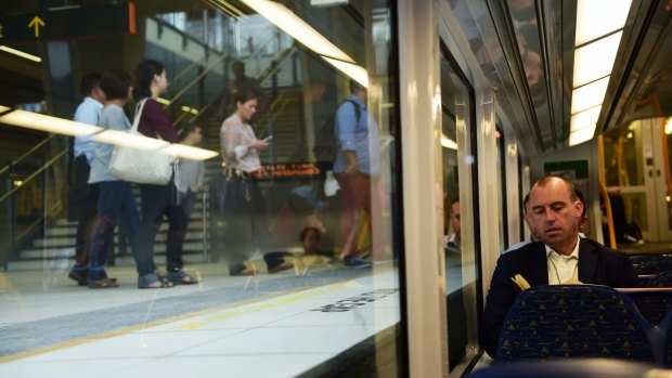 Justin Taylor reads his book after getting on at Leppington station. 