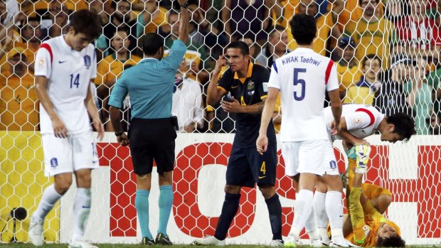Tim Cahill (centre) reacts as he is given a yellow card after a foul on South Korea's goalkeeper Kim Jin-hyeon (right) during the Asian Cup Group A match in Brisbane on Saturday.