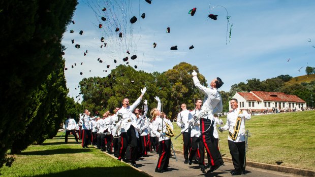 Graduates throw hats in the air at the Duntroon graduation ceremony.