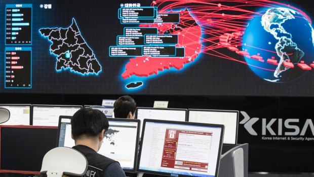 Employees watch electronic boards to monitor possible ransomware cyberattacks at the Korea Internet and Security Agency in Seoul, South Korea.