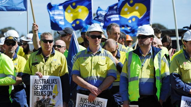 Workers from ASC listen to speakers outside the ship building headquarters in Adelaide.