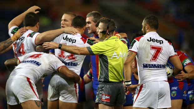 The clock's ticking: The referee instructs Knights and Dragons players to form a scrum and get on with the game.